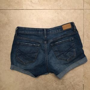 medium wash destroyed denim midi shorts